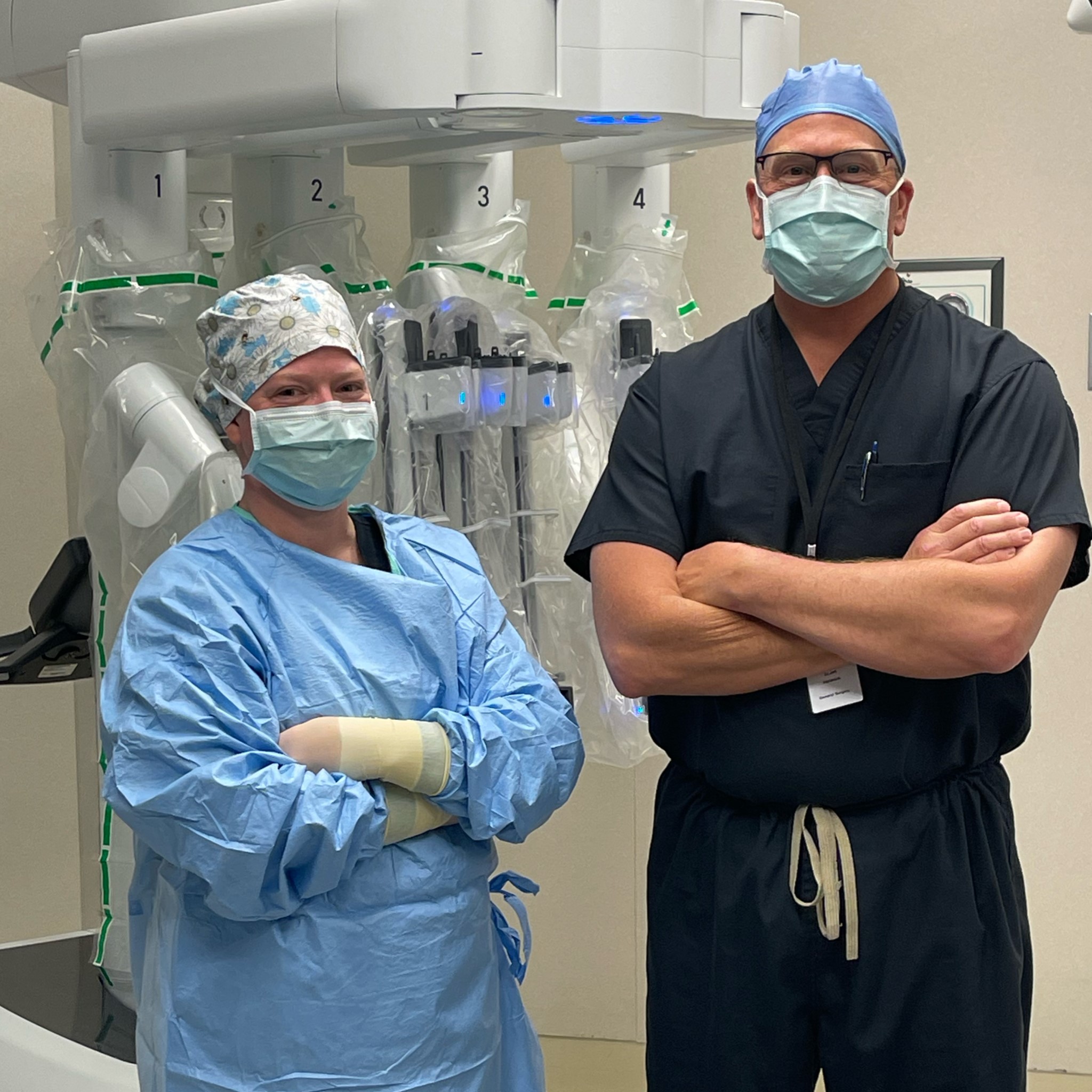 Nurse Carley and Dr. Helmink standing in front of new da Vinci Xi robot