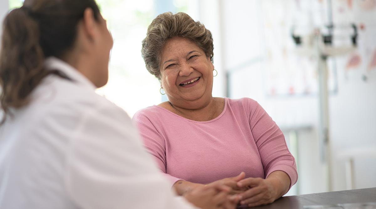 Hispanic female patient talking to a healthcare provider