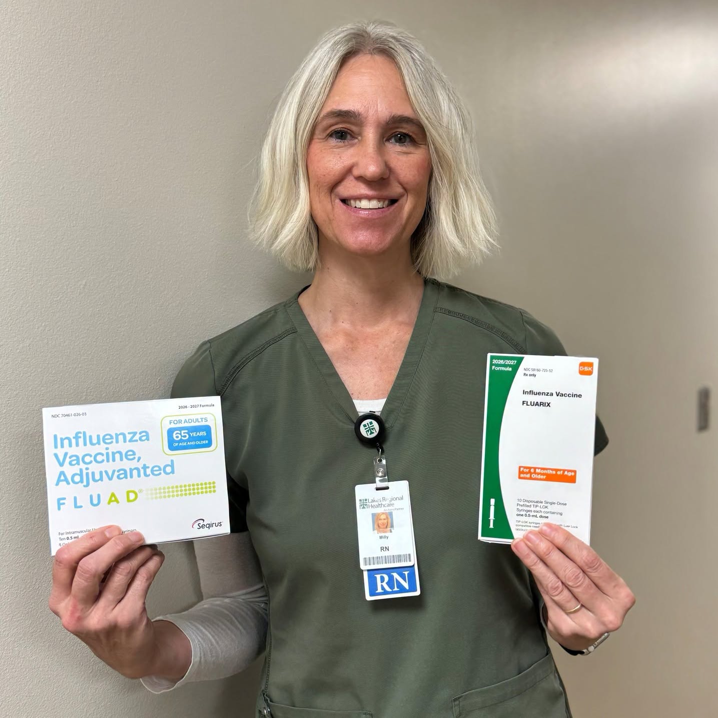 Dickinson County Public Health Nurse holding flu vaccine packaging and information